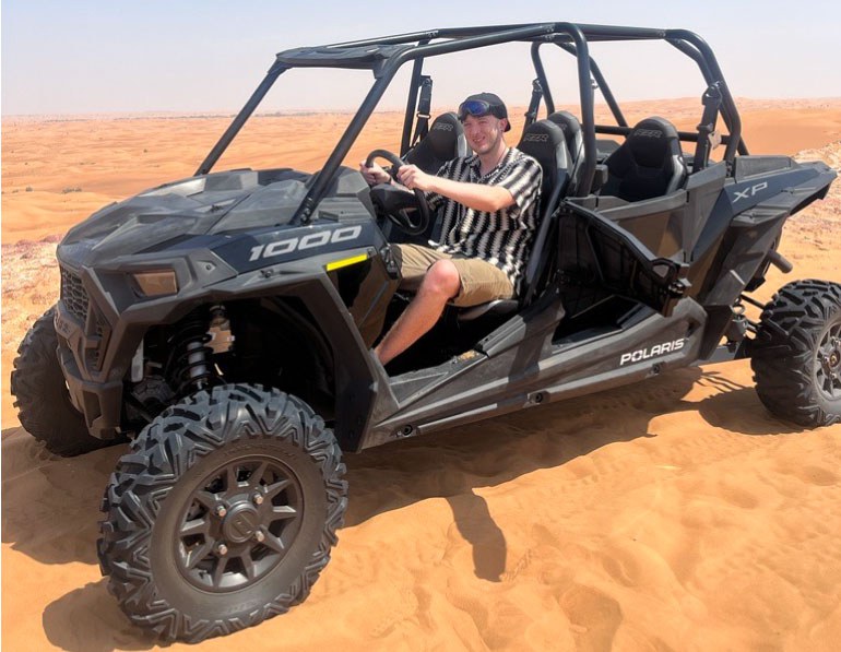 Josh riding dune buggy in Dubai