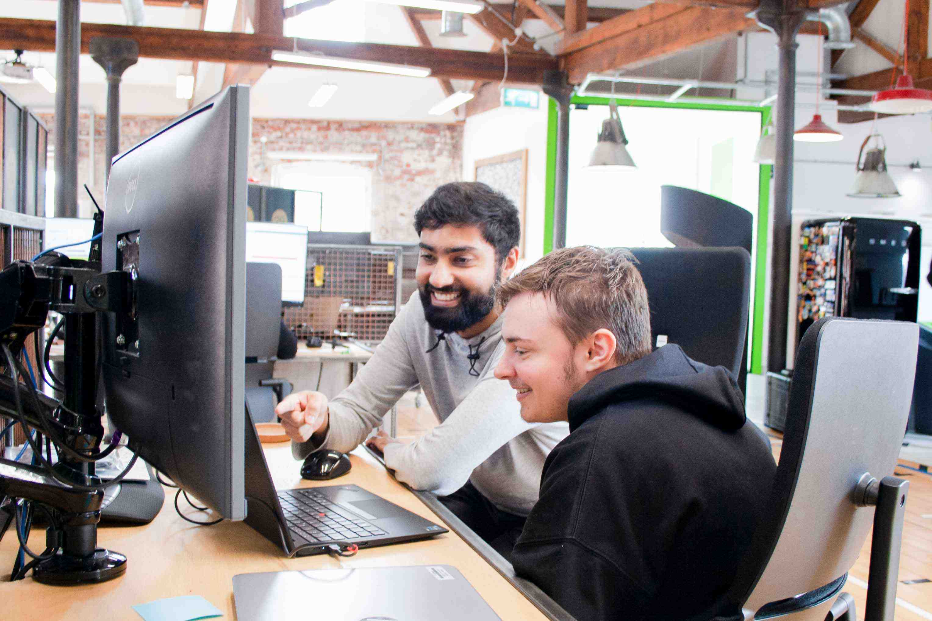 Sycous software developers working in office